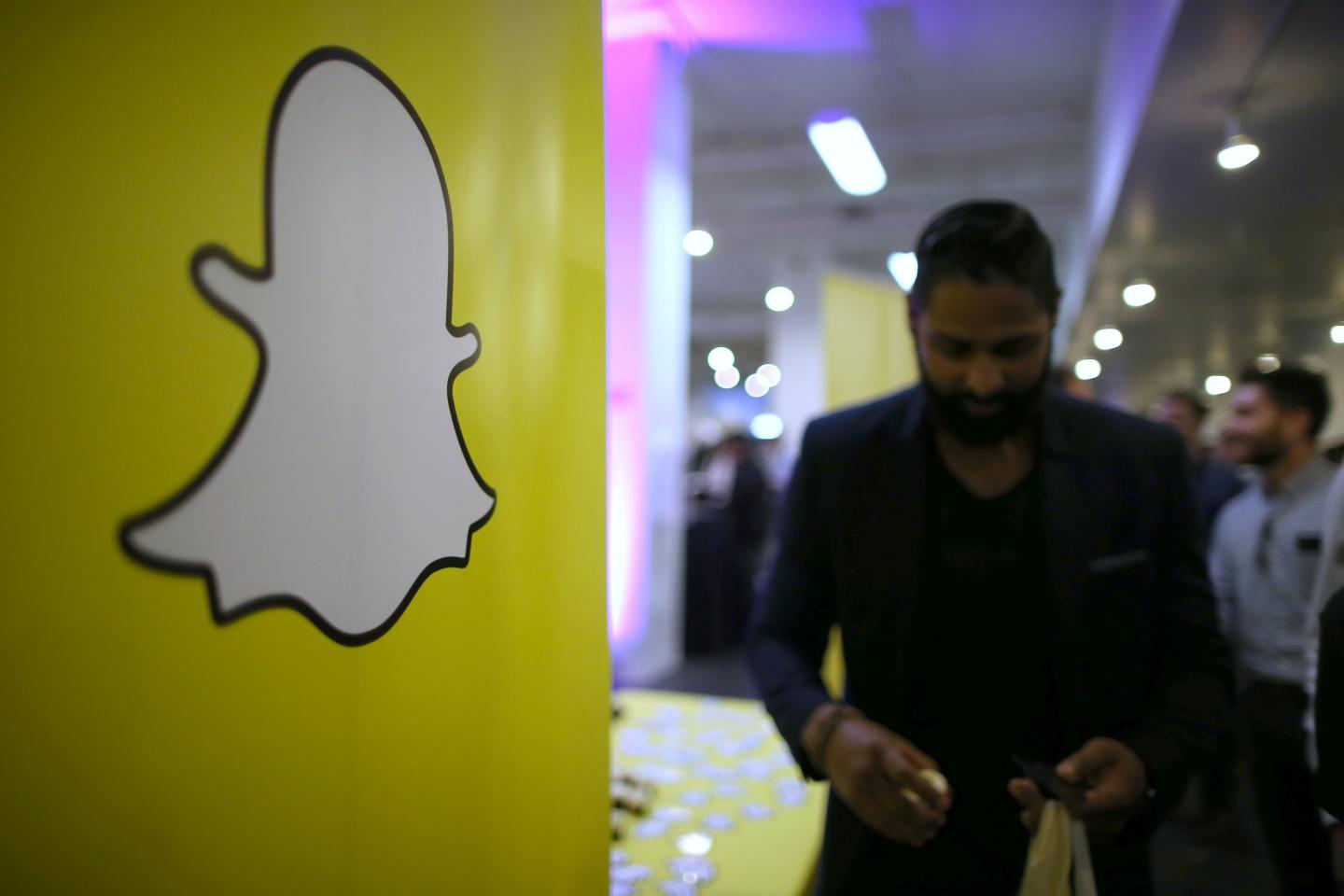 The logo of messaging app Snapchat is seen at a booth at TechFair LA, a technology job fair, in Los Angeles