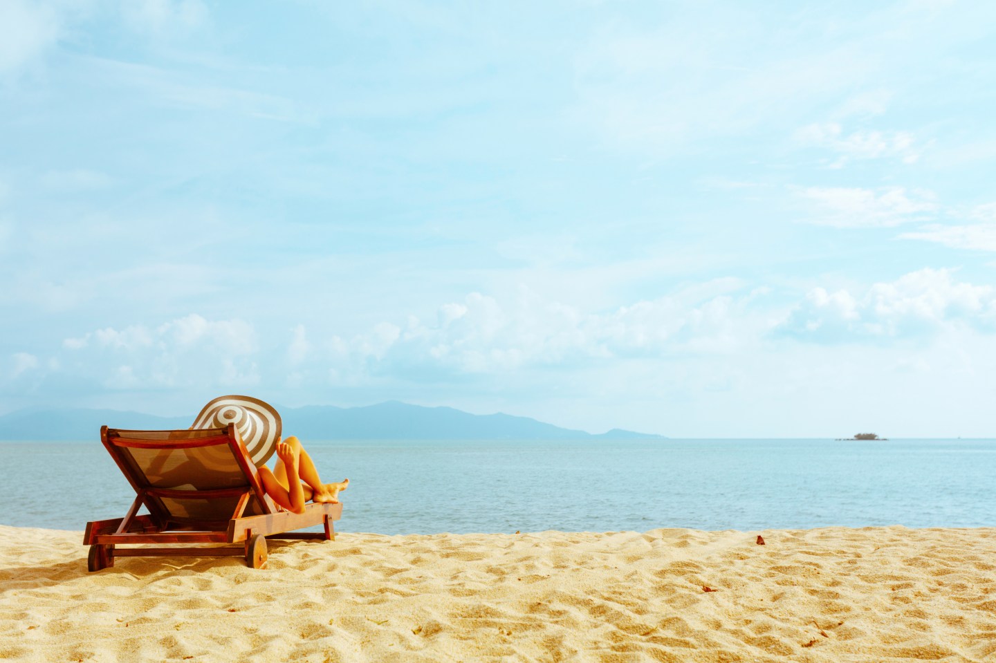 woman sunbathing in beach chair