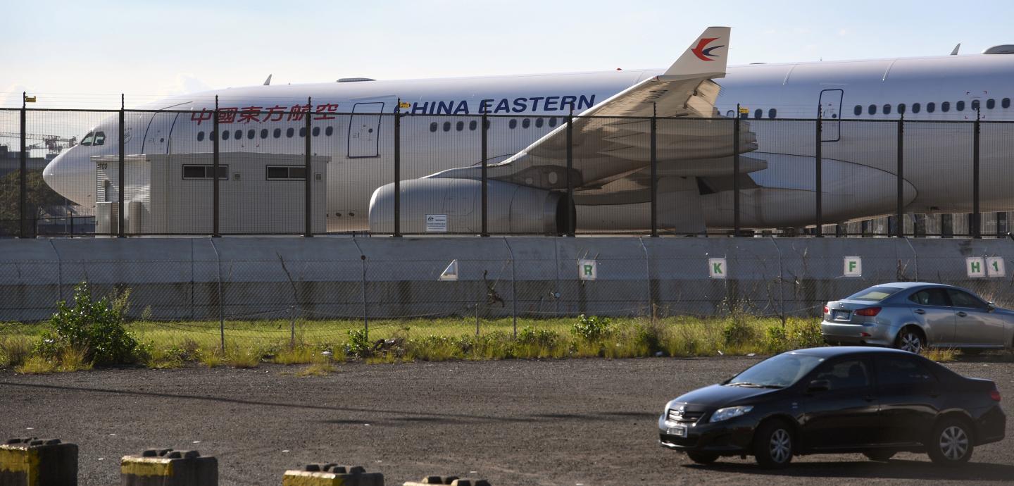 A China Eastern Airbus A330 passenger aircraft, which suffered a serious fault to its starboard engine following take-off, sits on the tarmac at Sydney Airport on June 12, 2017.