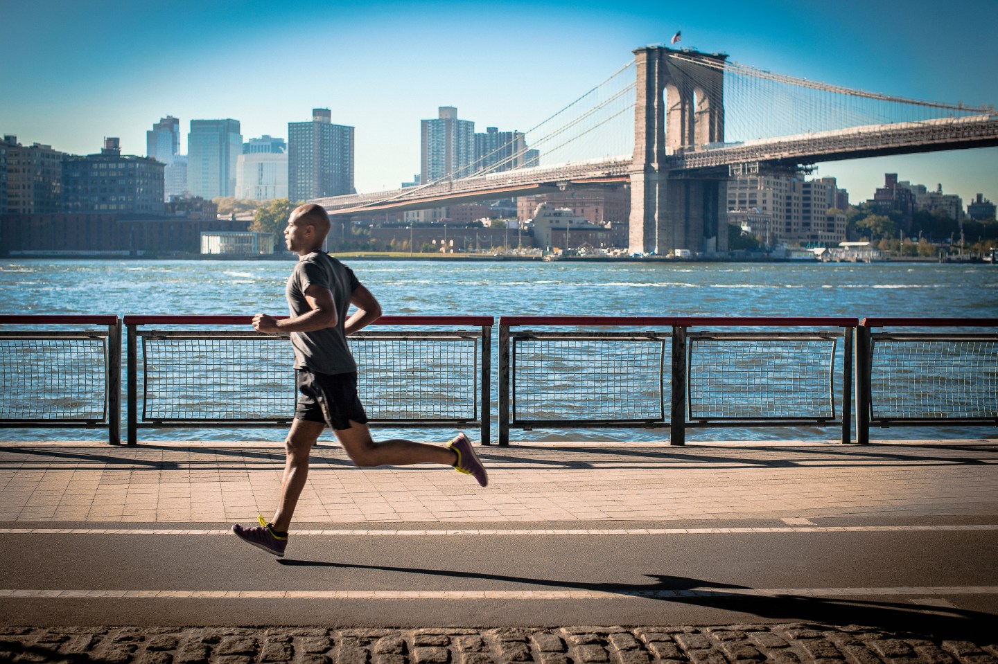 Mature man running along waterfront, New York, USA