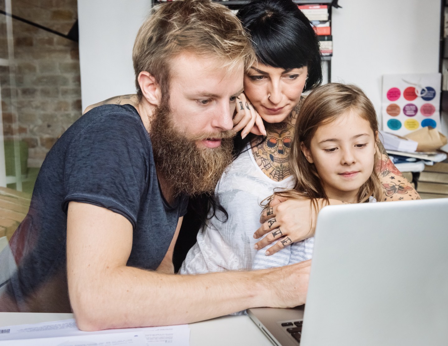 Young Family Browsing Internet With Laptop