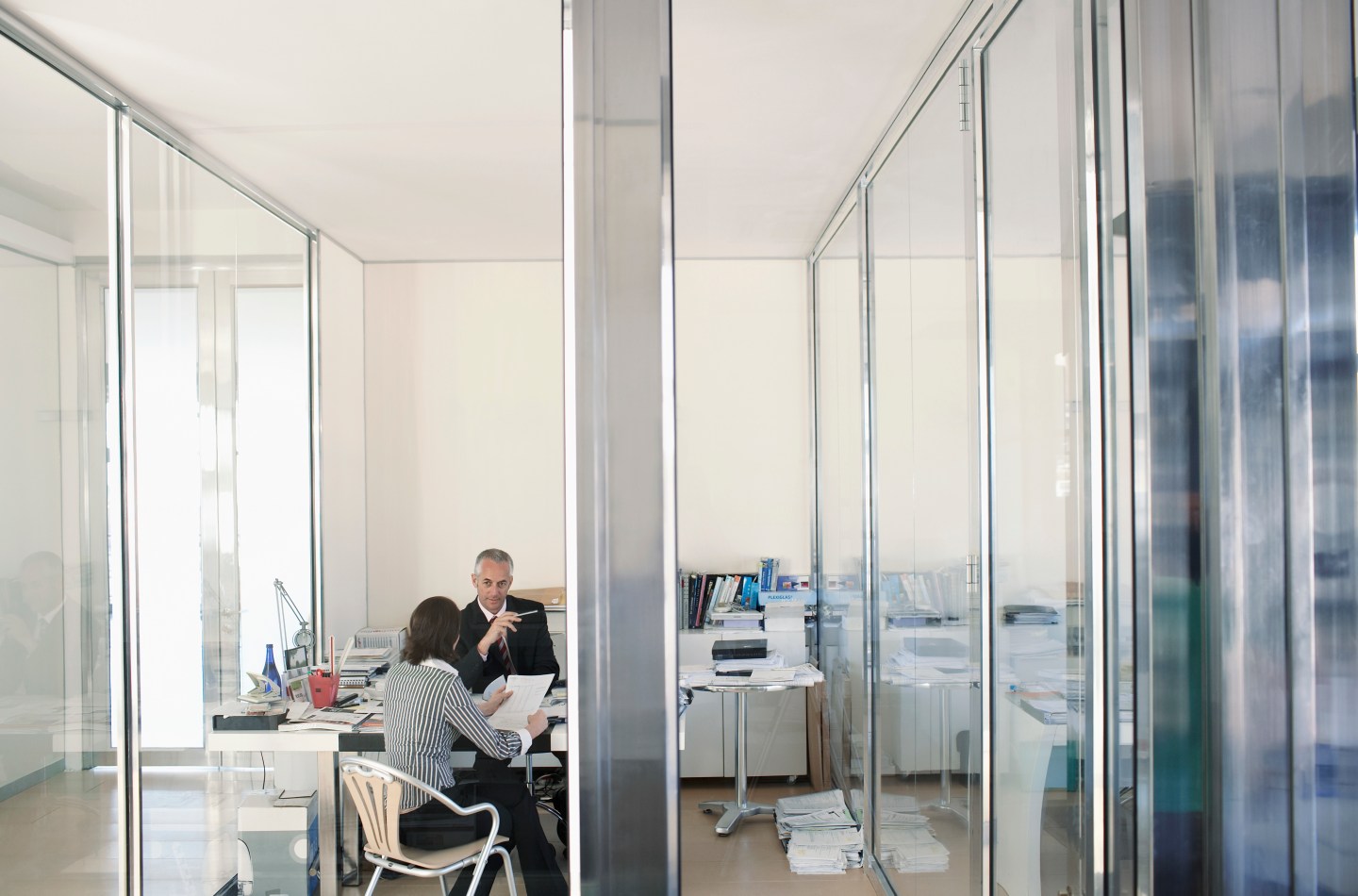 Two businesspeople sitting in office having meeting elevated view