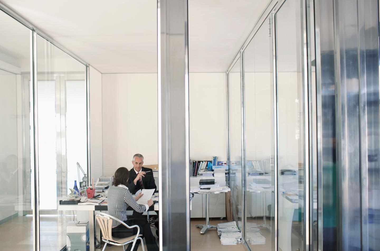 Two businesspeople sitting in office having meeting elevated view