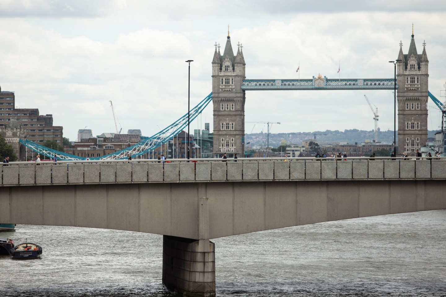 People walk along London Bridge following the June 3rd terror attack on June 5, 2017 in London, England.