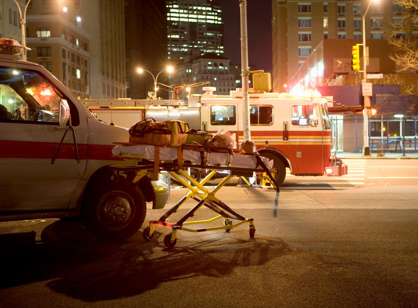 Fire truck, ambulance and  in street, night