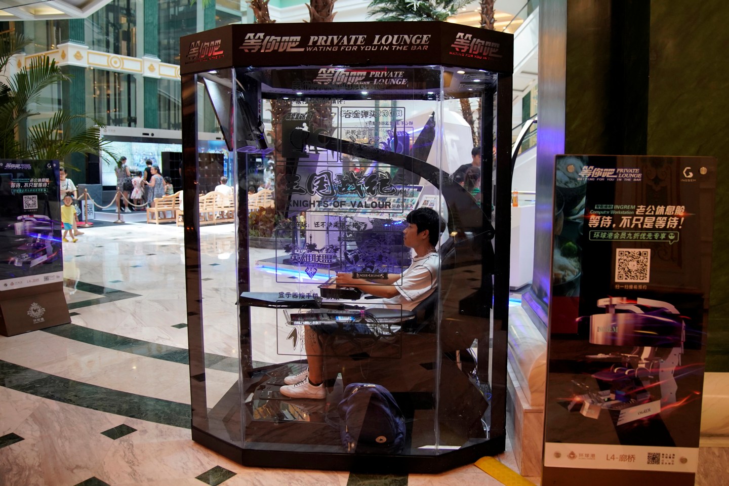 An employee demonstrates a "husband pod" at a shopping mall in Shanghai