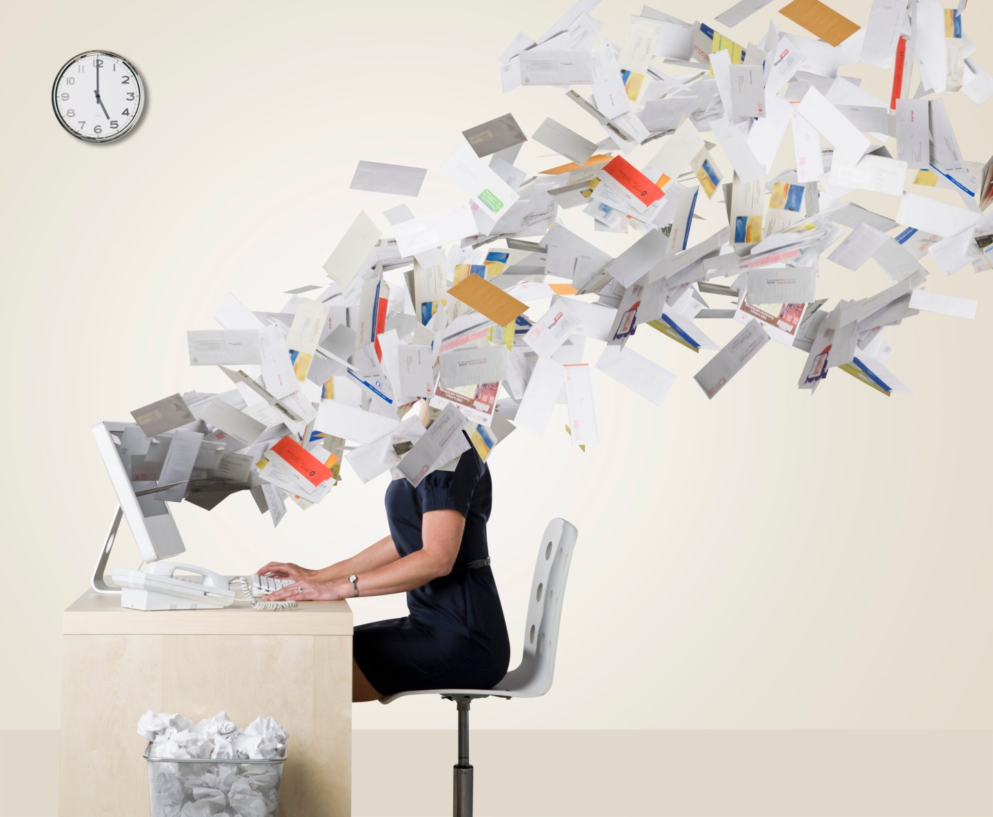 Businesswoman's head covered with flying paperwork