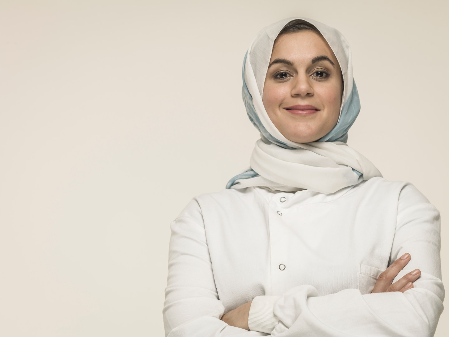Woman wearing laboratory coat and hijab head scarf