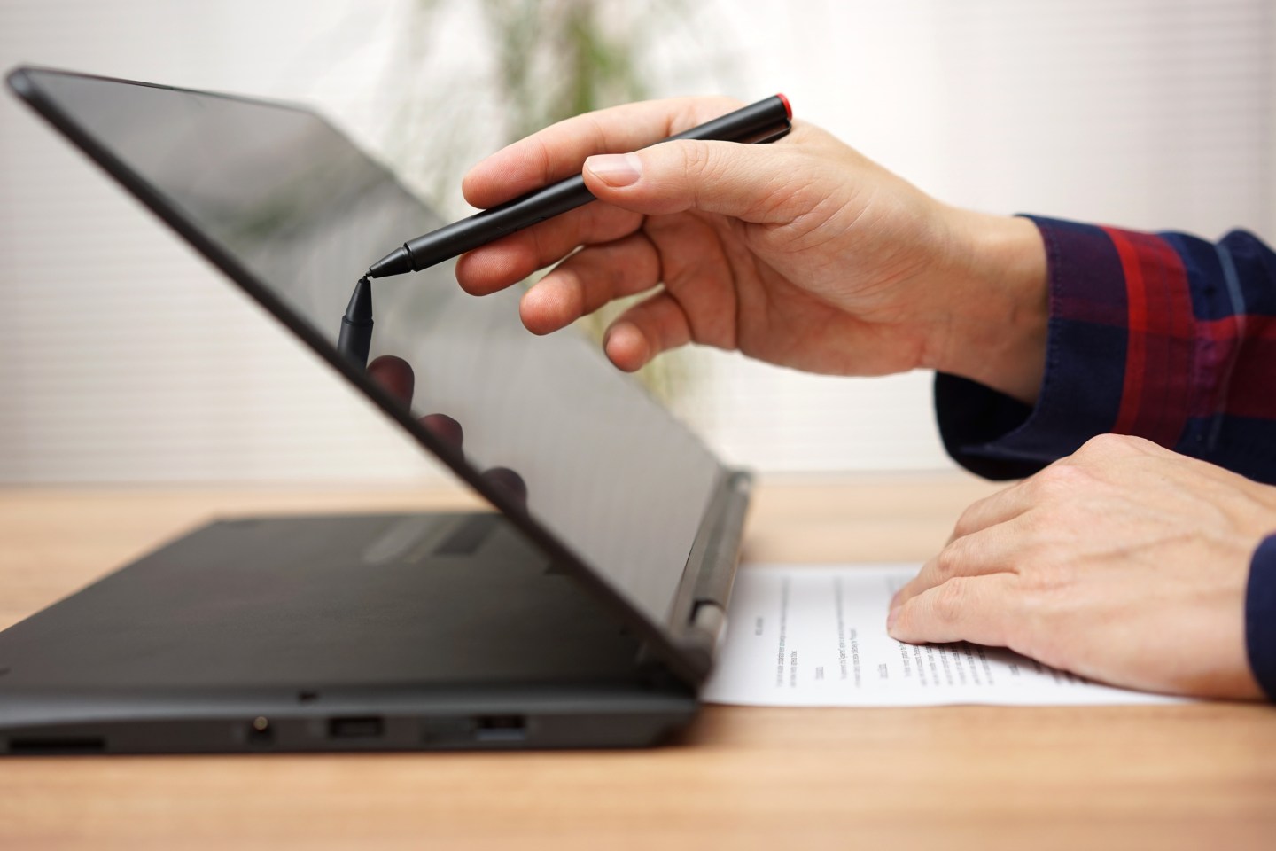 Student is taking on line course on touchscreen laptop computer