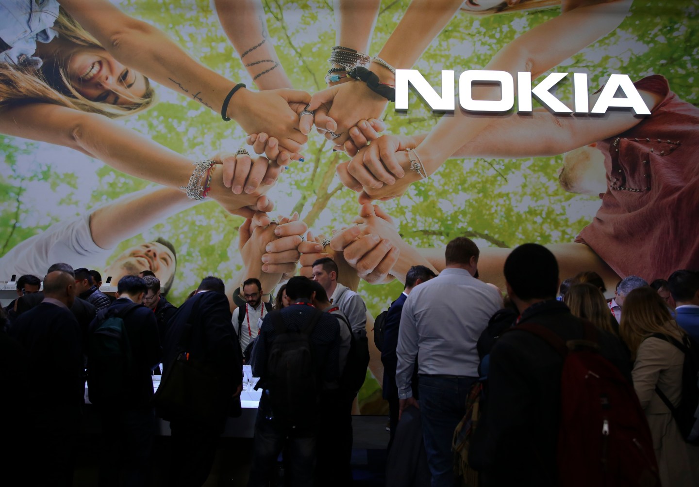 People check devices inside Nokia booth at Mobile World Congress in Barcelona