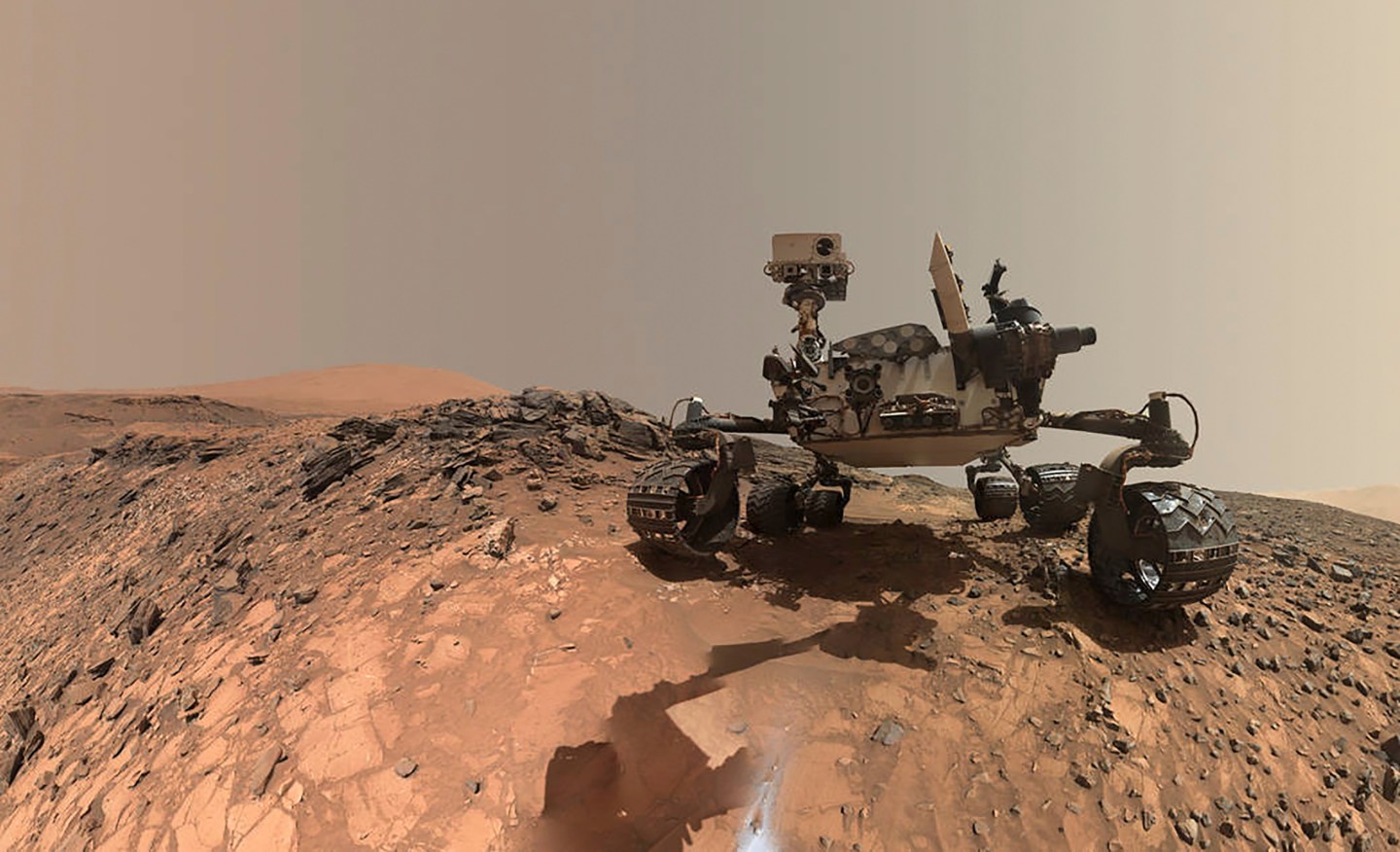NASA's Curiosity Mars rover is seen at the site from which it reached down to drill into a rock target called 'Buckskin' on lower Mount Sharp