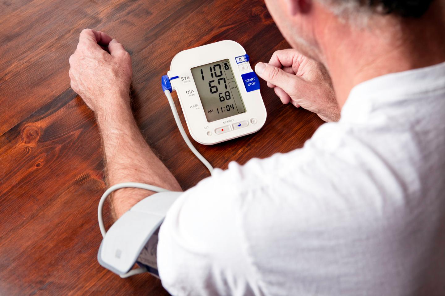 Mature adult man checking blood pressure