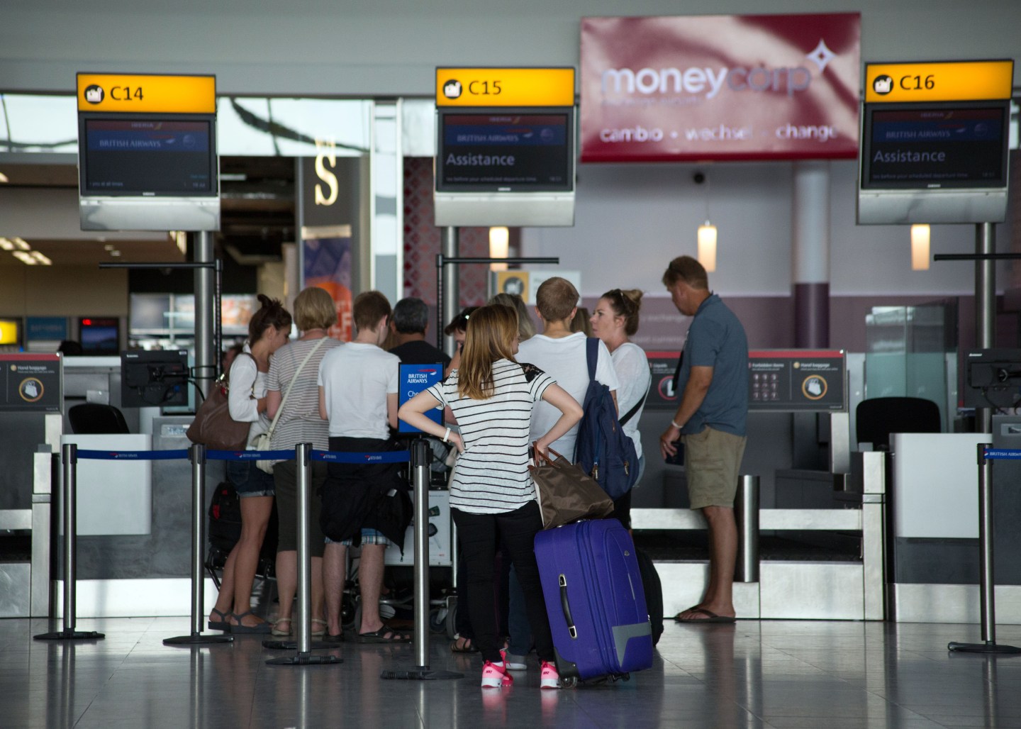 Passengers queues to drop their bags off as they check-in for their flights in Terminal 5 of Heathrow Airport.