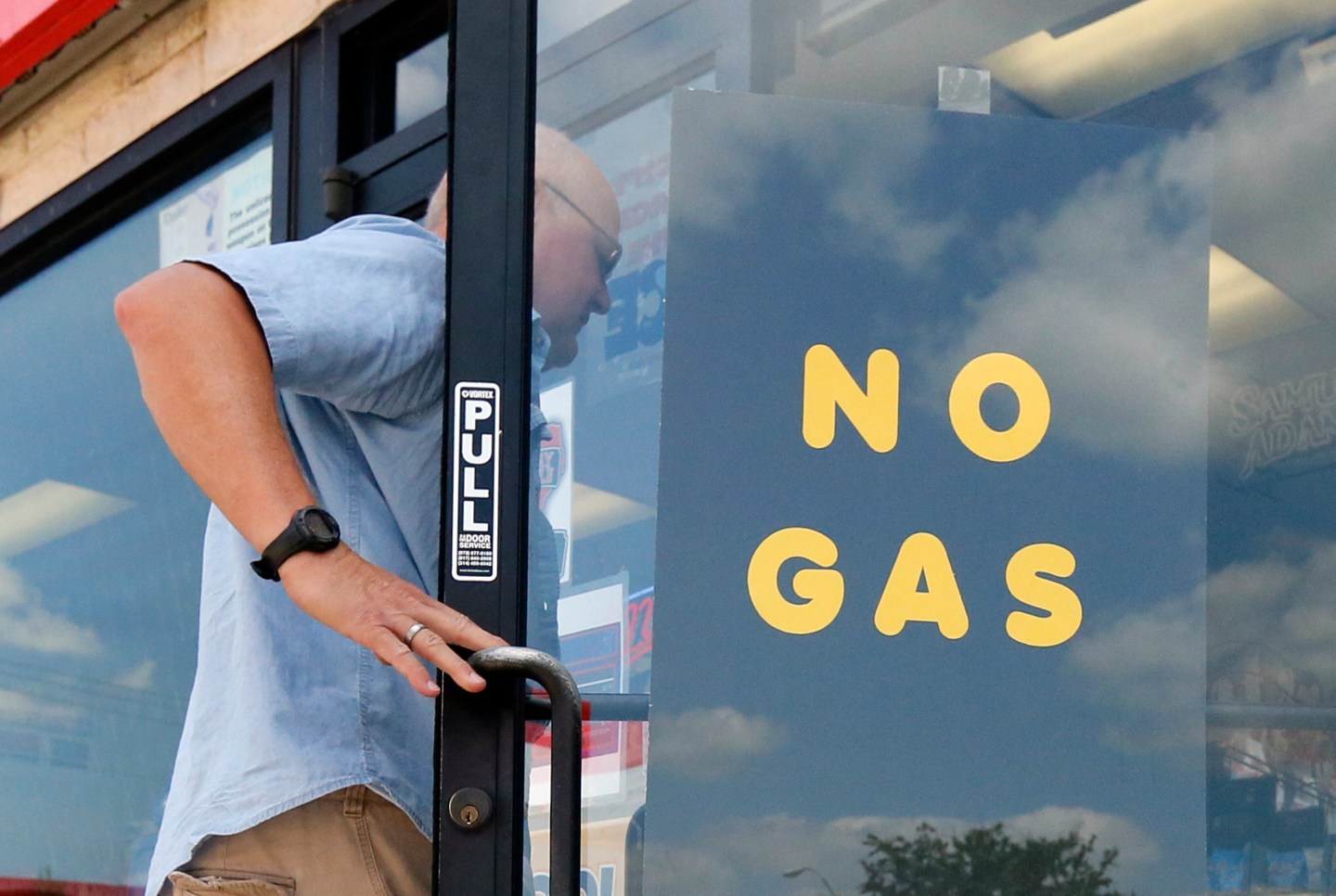 A customer walks into an Exxon filling station and convenience store location where a sign on the door reads, "No Gas," Aug. 31, 2017, in Bedford, Texas.