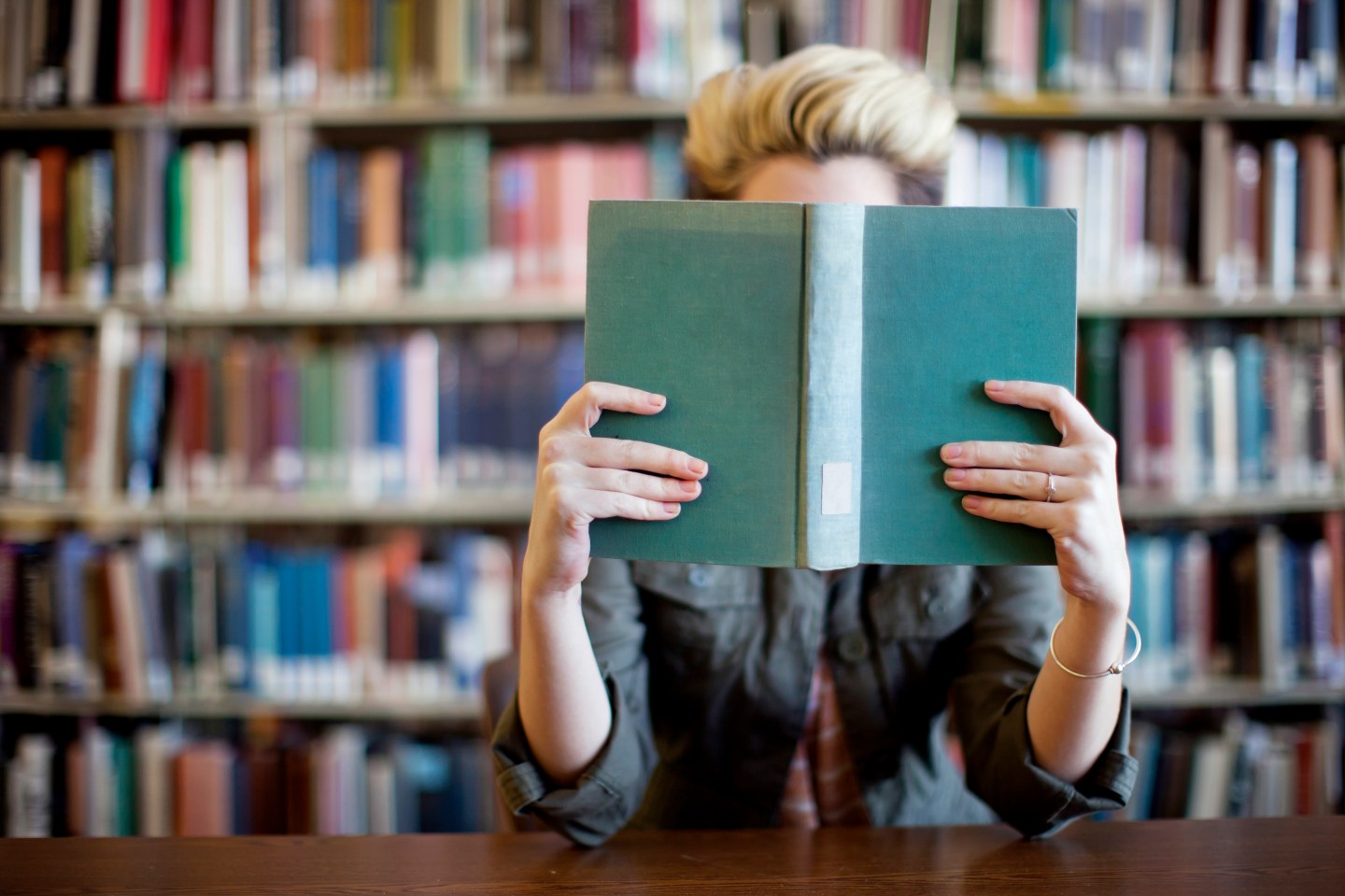 Woman reading book in library