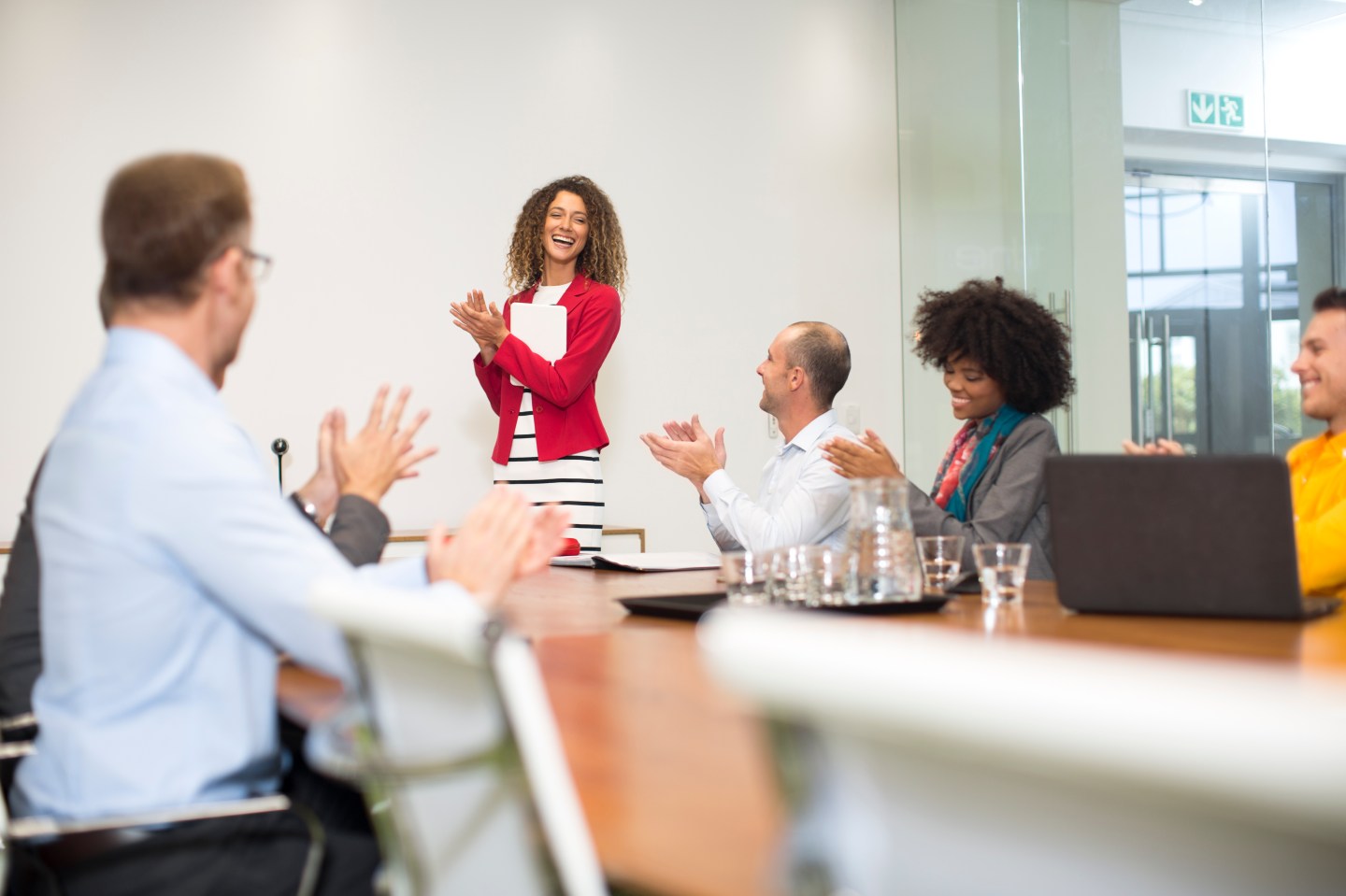 Business people applauding during a meeting in boardroom
