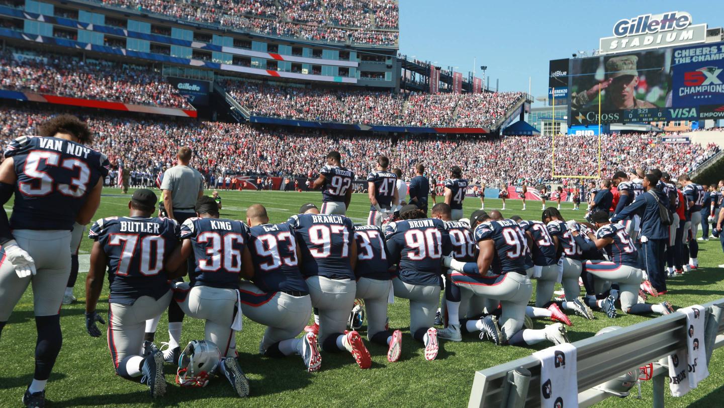 New England Patriots players take a knee during the national anthem before the start of a game against the Houston Texans at Gillette Stadium in Foxborough, Mass., Sept. 24, 2017.