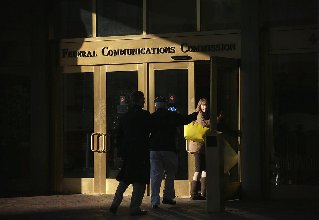 WASHINGTON, DC - DECEMBER 11:  People enter the building of Federal Communications Commission December 11, 2014 in Washington, DC. The commission held its monthly meeting as activists held a rally outside to call for net neutrality.  (Photo by Alex Wong/Getty Images)