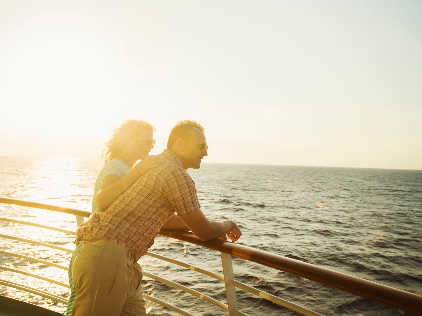 Caucasian couple admiring view from boat deck