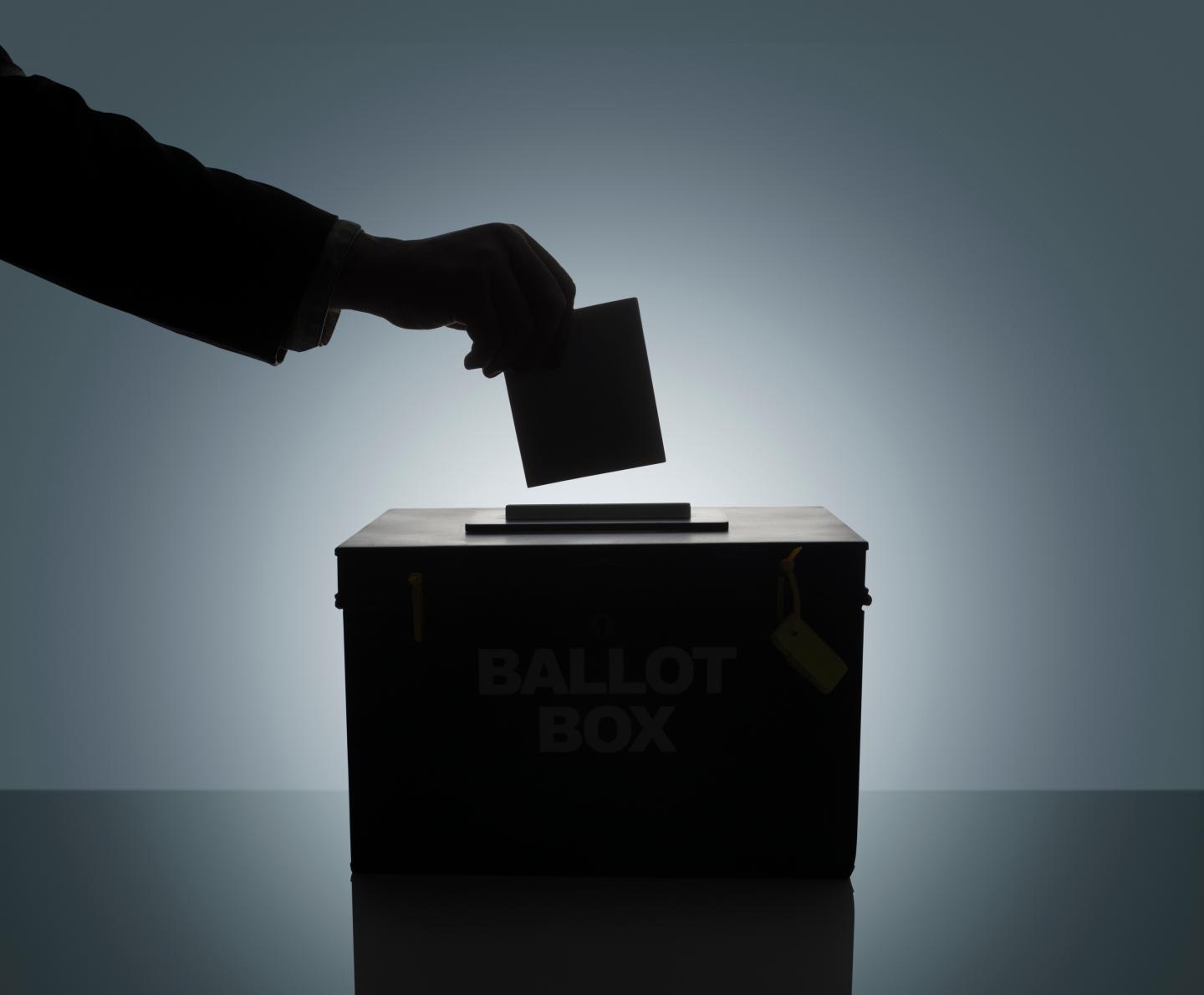 Silhouette of man casting his vote