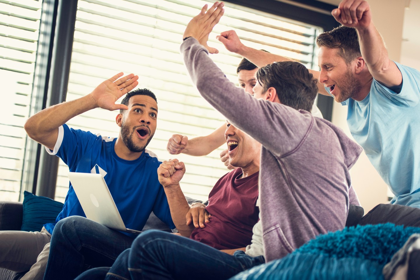Group of frends watching game on laptop