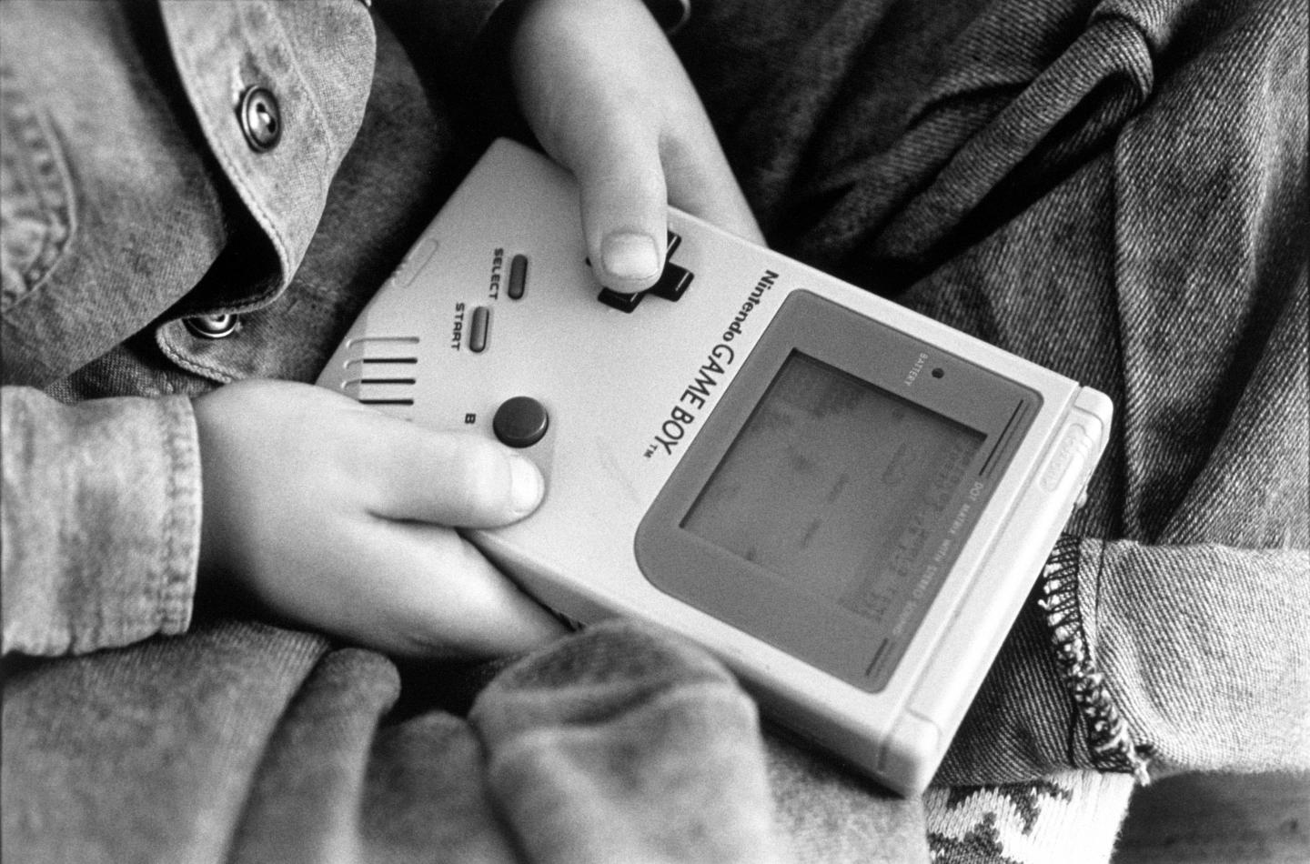 London - A boy playing on one of the first Nintendo Game Boy computers