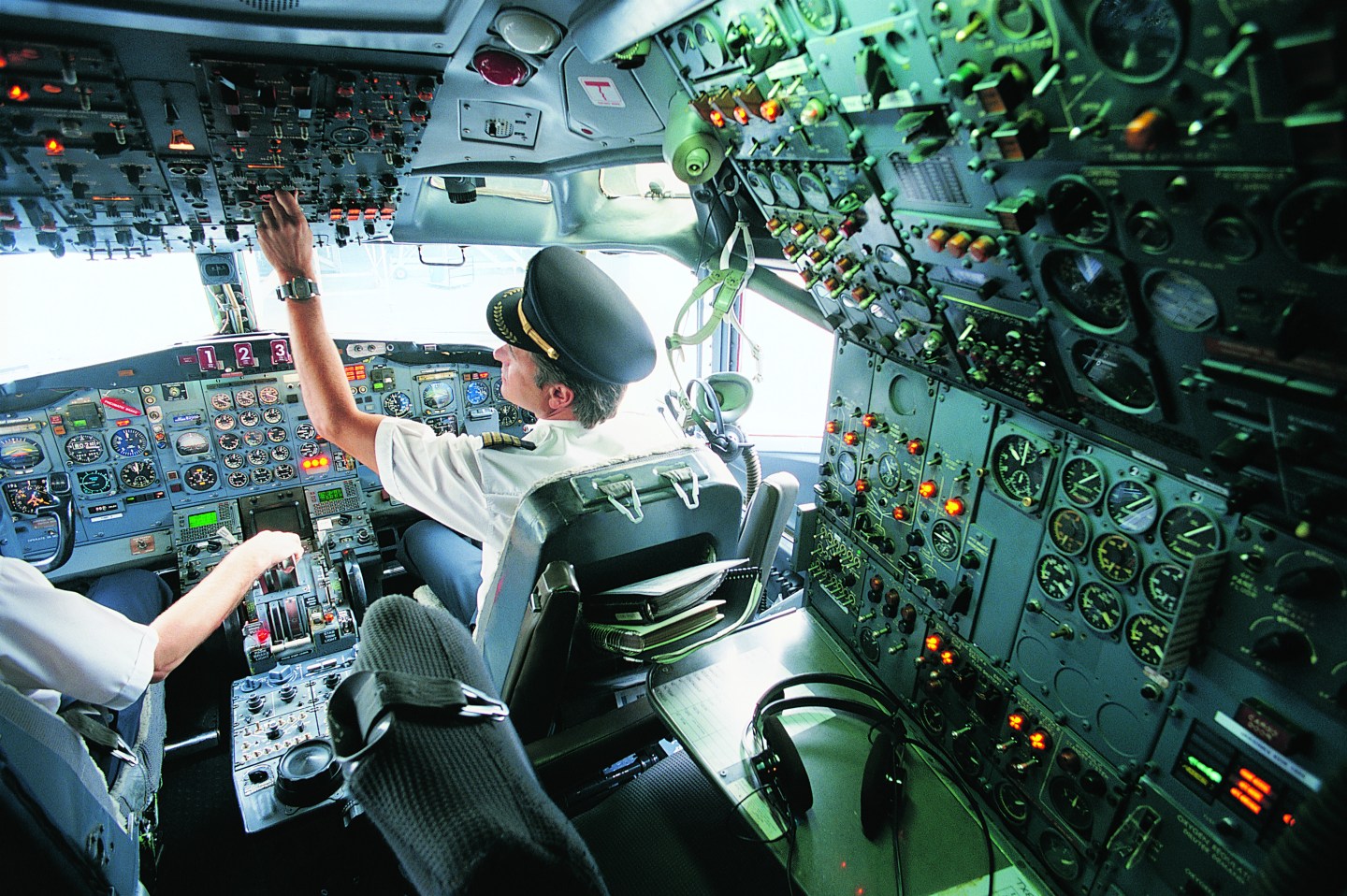 Pilot Switching a Control in the Cockpit of a Commercial Aeroplane