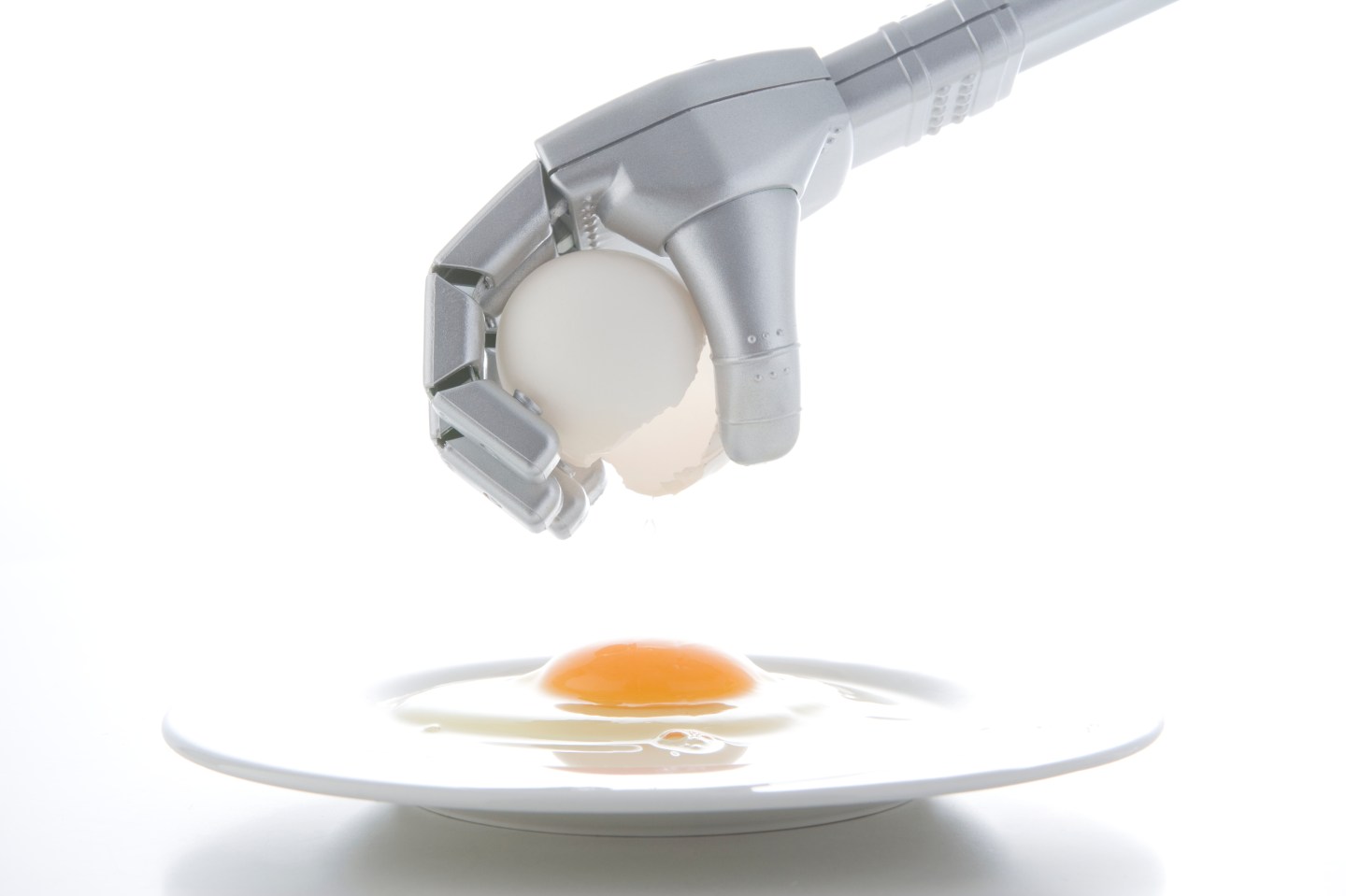 Robotic arm cracking egg