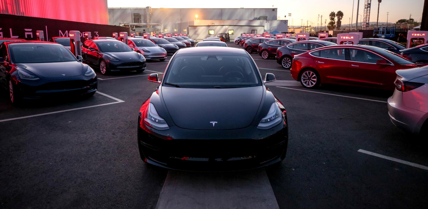 FILE PHOTO: Tesla Model 3 cars are seen as Tesla holds an event at the factory handing over its first 30 Model 3 vehicles to employee buyers at the companys Fremont facility in California