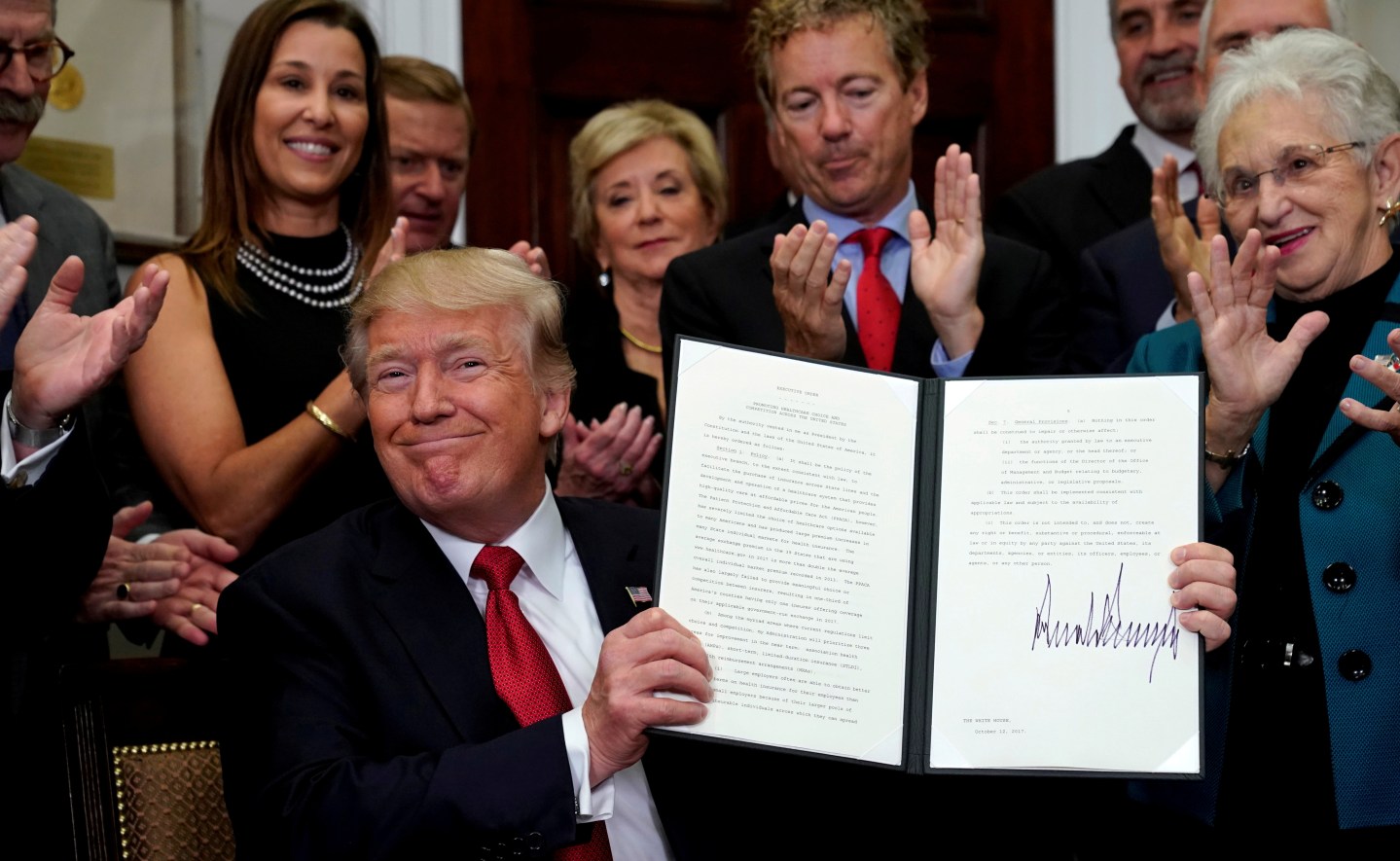 FILE PHOTO: Trump signs an Executive Order on healthcare at the White House in Washington