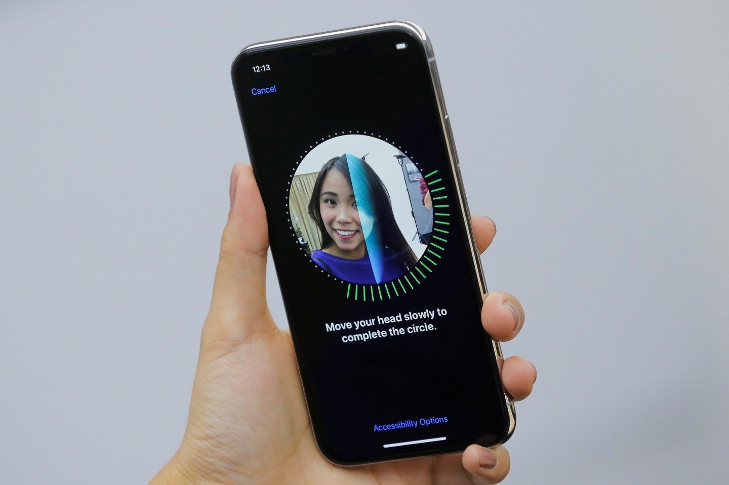 An attendee uses the Face ID function on the new iPhone X during a presentation for the media in Beijing