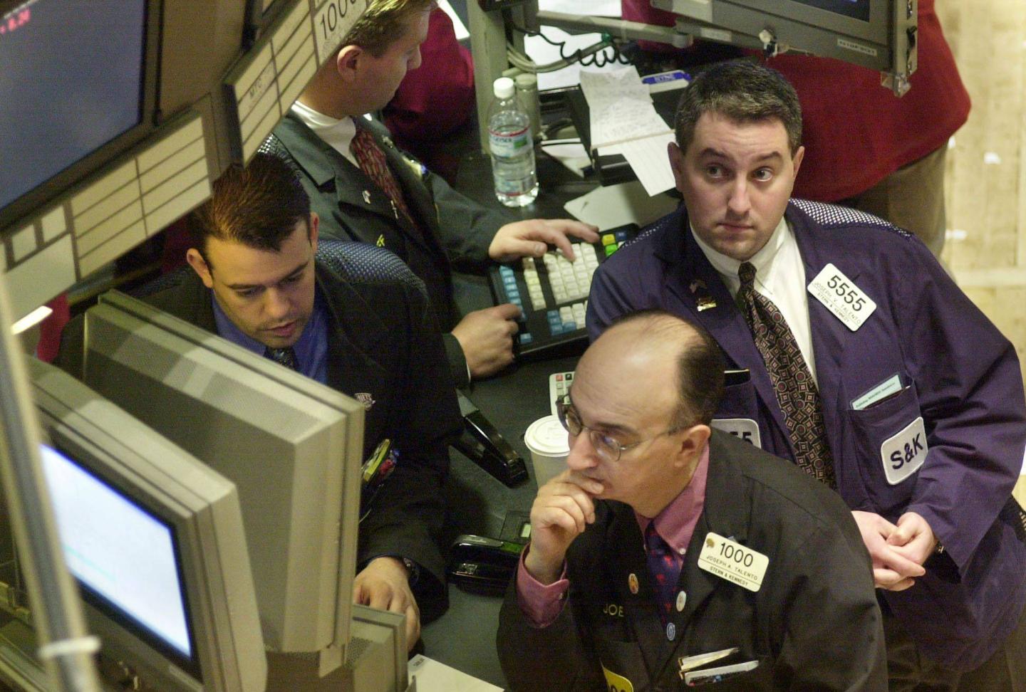 Stock investors watching stock prices fall during a market crash.