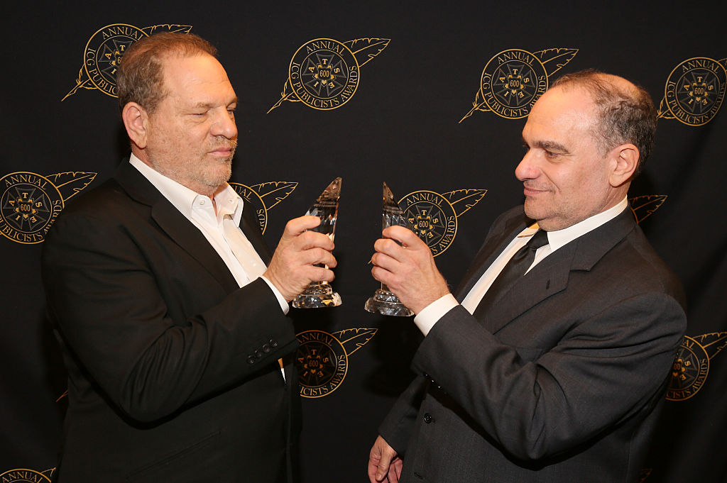 Harvey and Bob Weinstein toast each other.