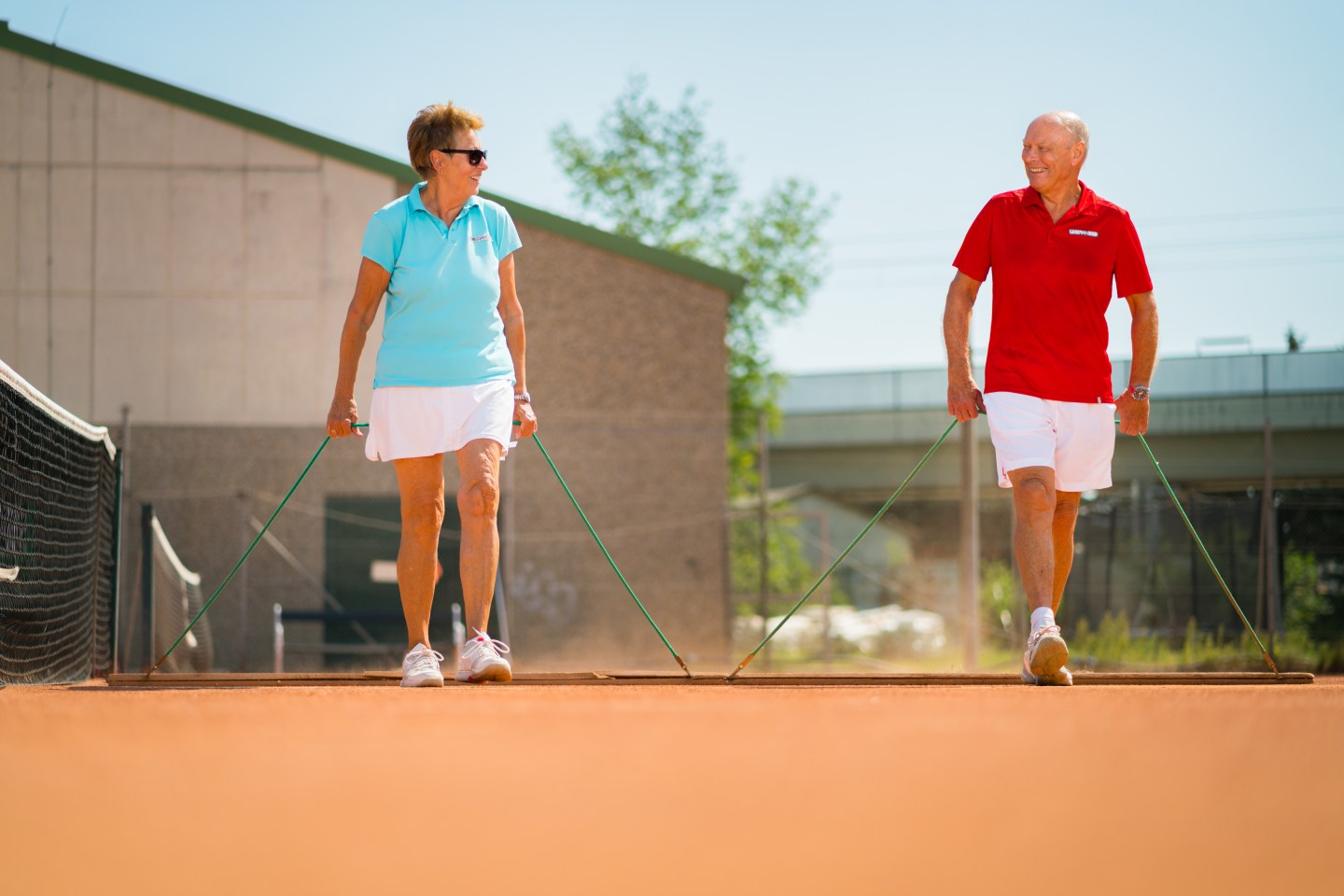 A retired couple prepares to play tennis
