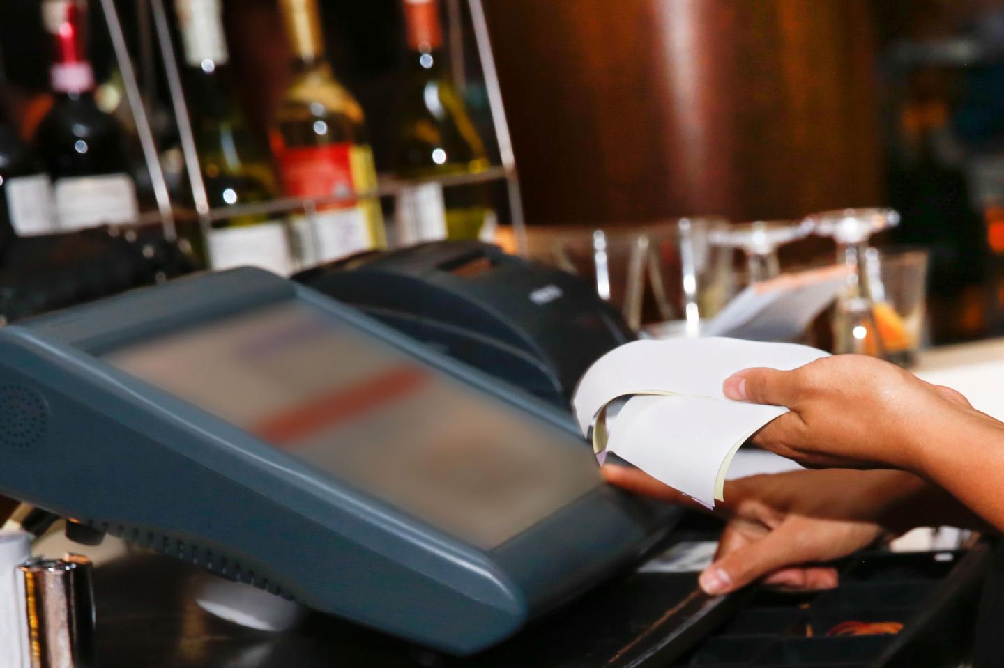 Cashier holding receipt