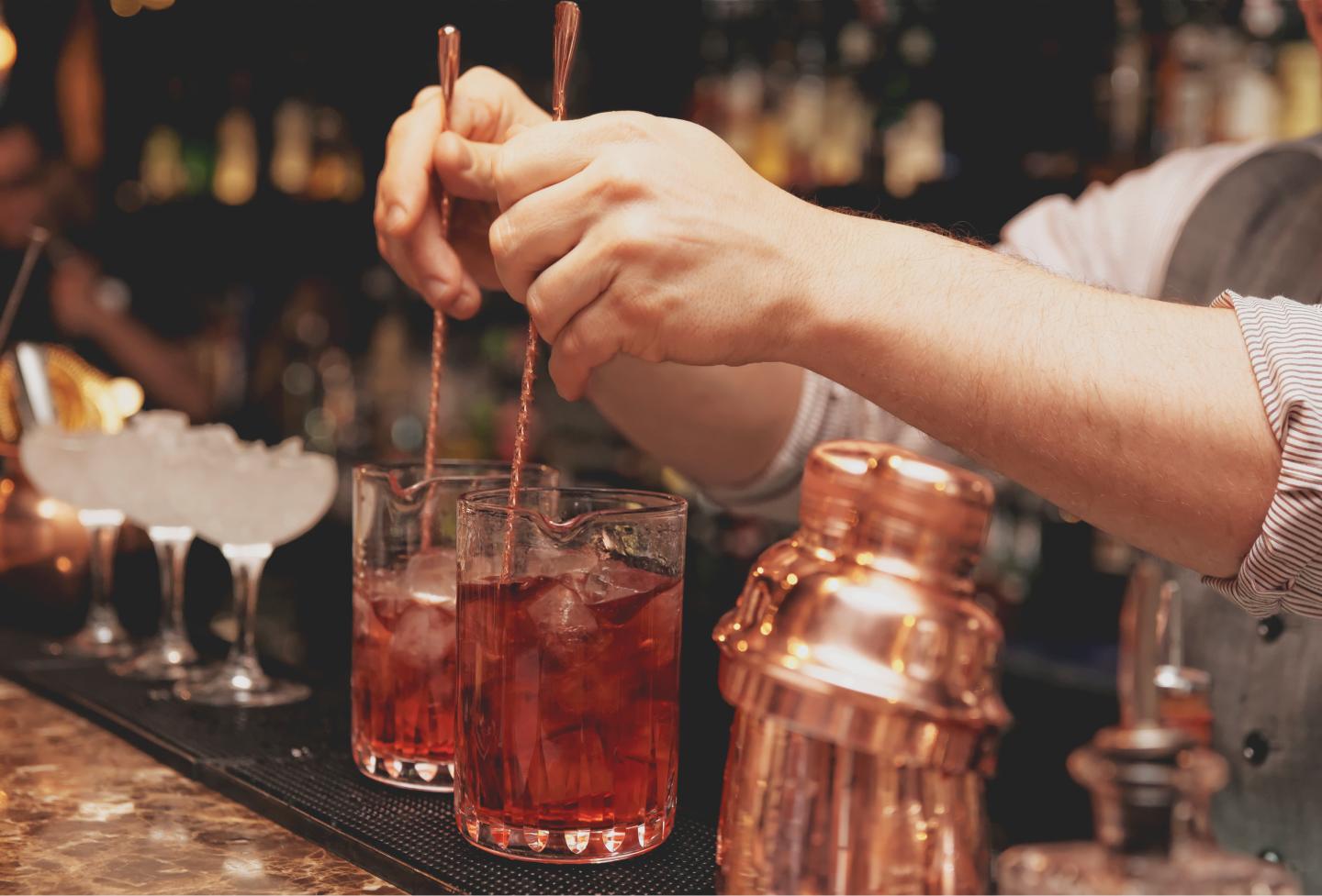Bartender is stirring cocktails, toned image