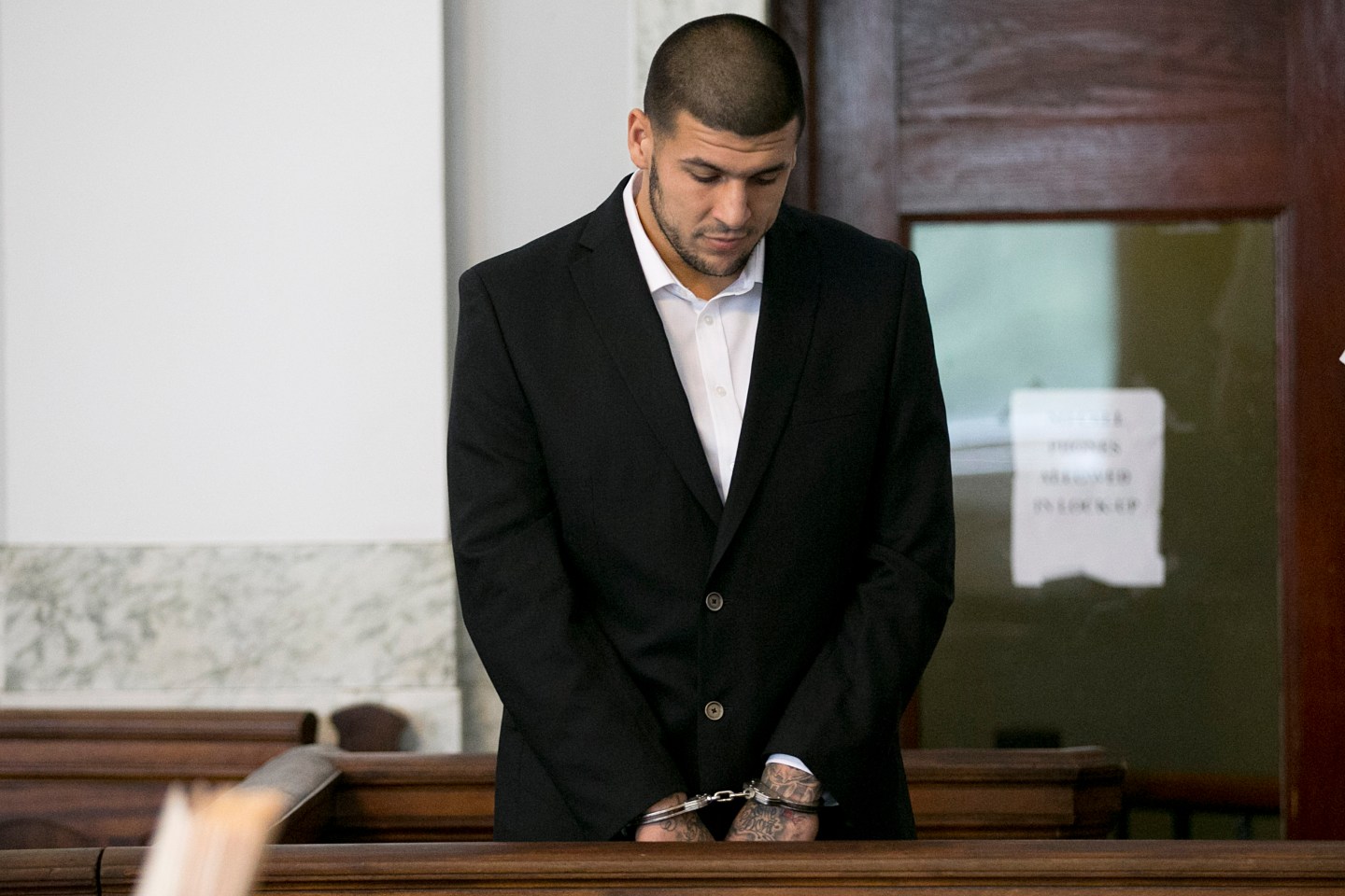 Aaron Hernandez looking down at the ground during a court appearance in 2013