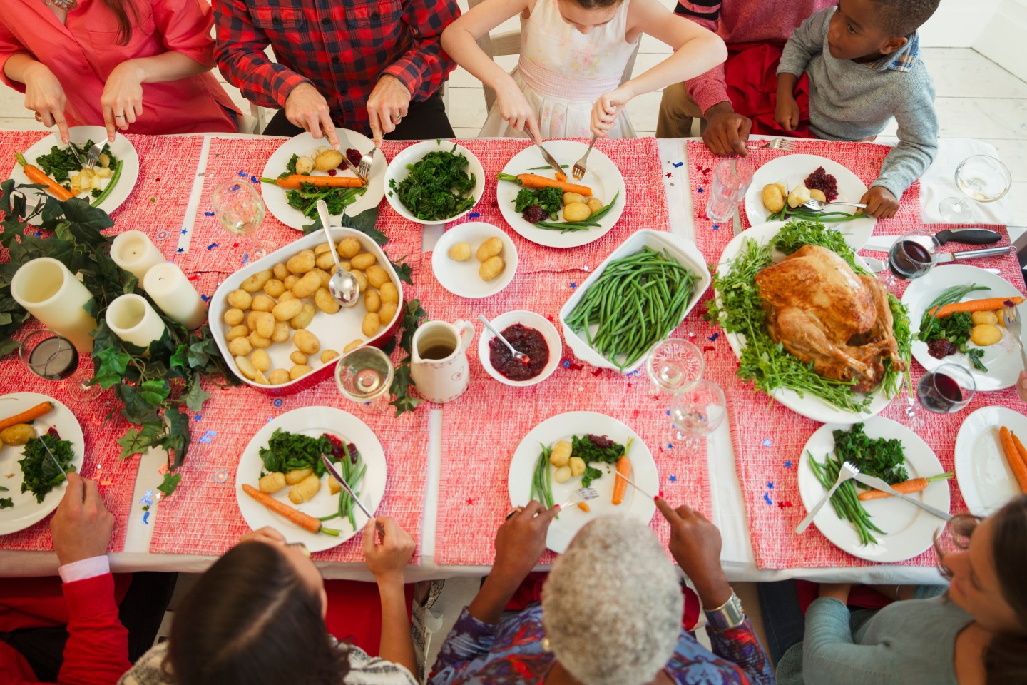 Overhead view family eating Christmas dinner