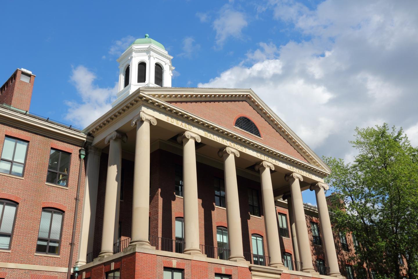 Upshot of brick university building against blue sky