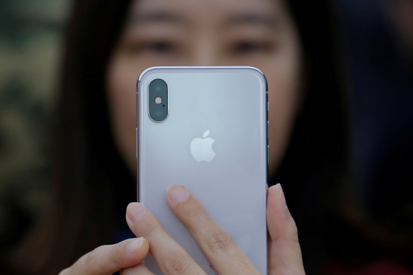 A attendee uses a new iPhone X during a presentation for the media in Beijing