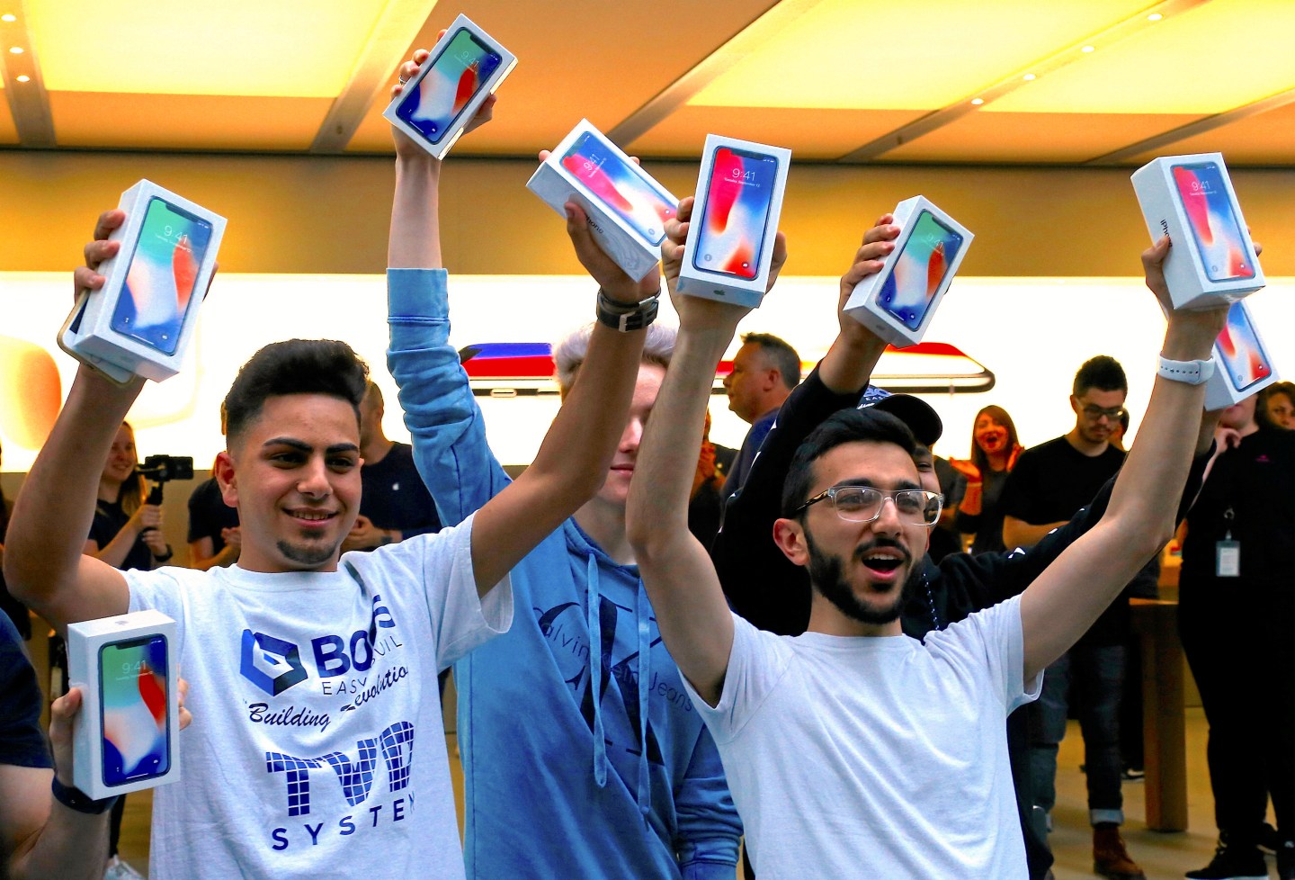 The first customers to buy the iPhone X react during global launch of the new Apple product in central Sydney