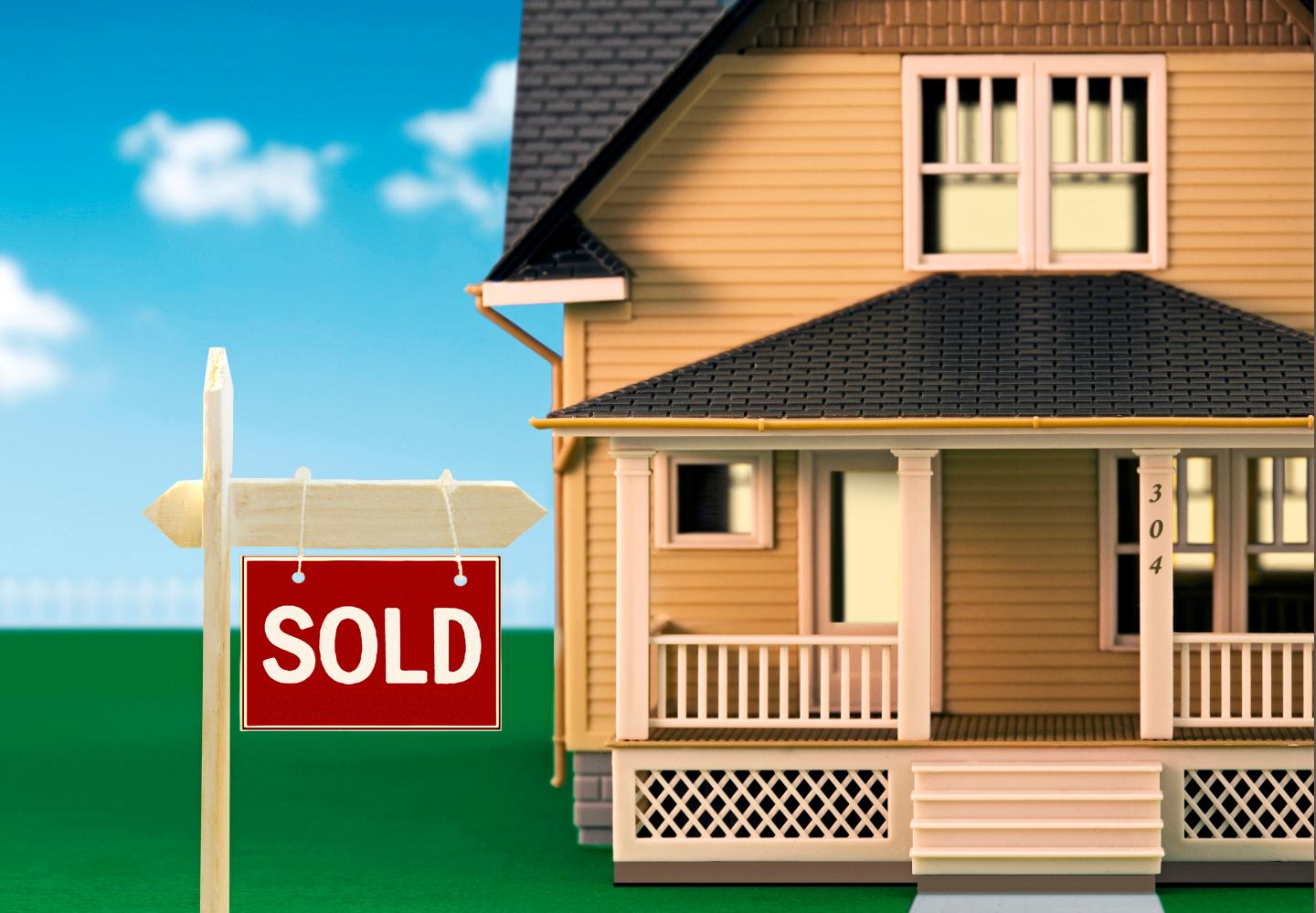 Sold sign in front of model houses