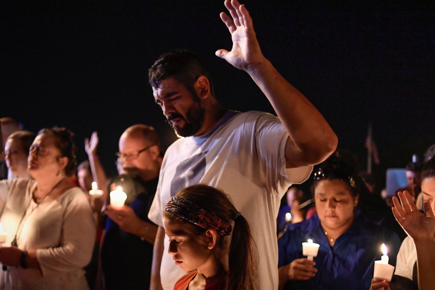 Local residents embrace during a candlelight vigil for victims of a mass shooting in a church in Sutherland Springs, Texas