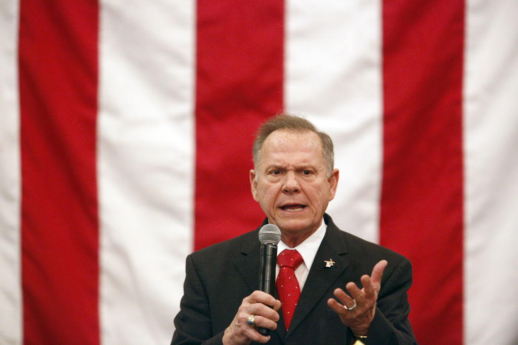 Republican Senate Candidate Roy Moore appears before American flag at campaign rally