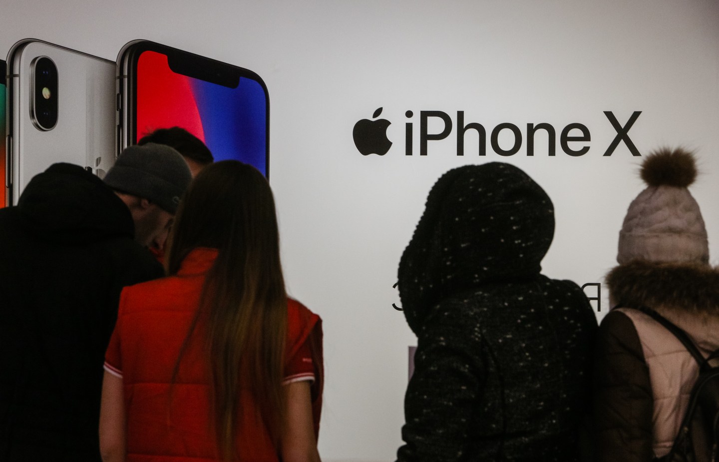 People gather around an Apple iPhone X promotion table in Kyiv, Ukraine, Dec.12, 2017. iPhone X official sales started in Ukraine.