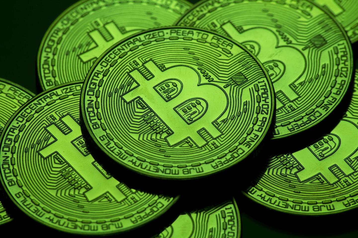 A green visual representation of the cryptocurrency Bitcoin.