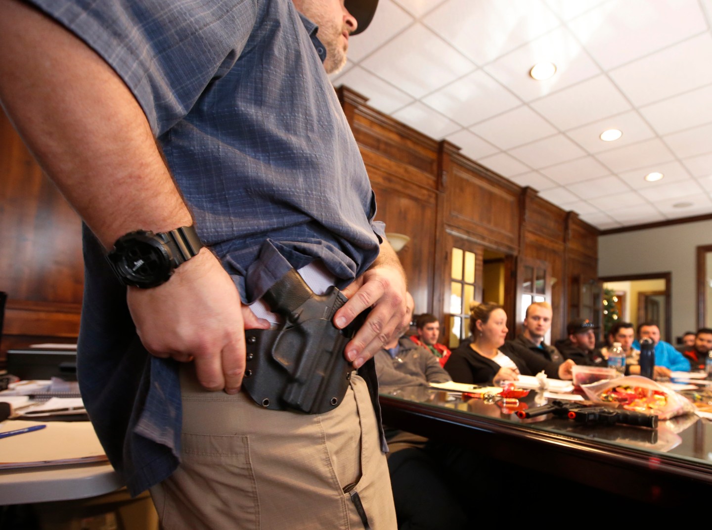 Damon Thueson shows a holster at a gun concealed carry permit class put on by "USA Firearms Training" on December 19, 2015 in Provo, Utah.