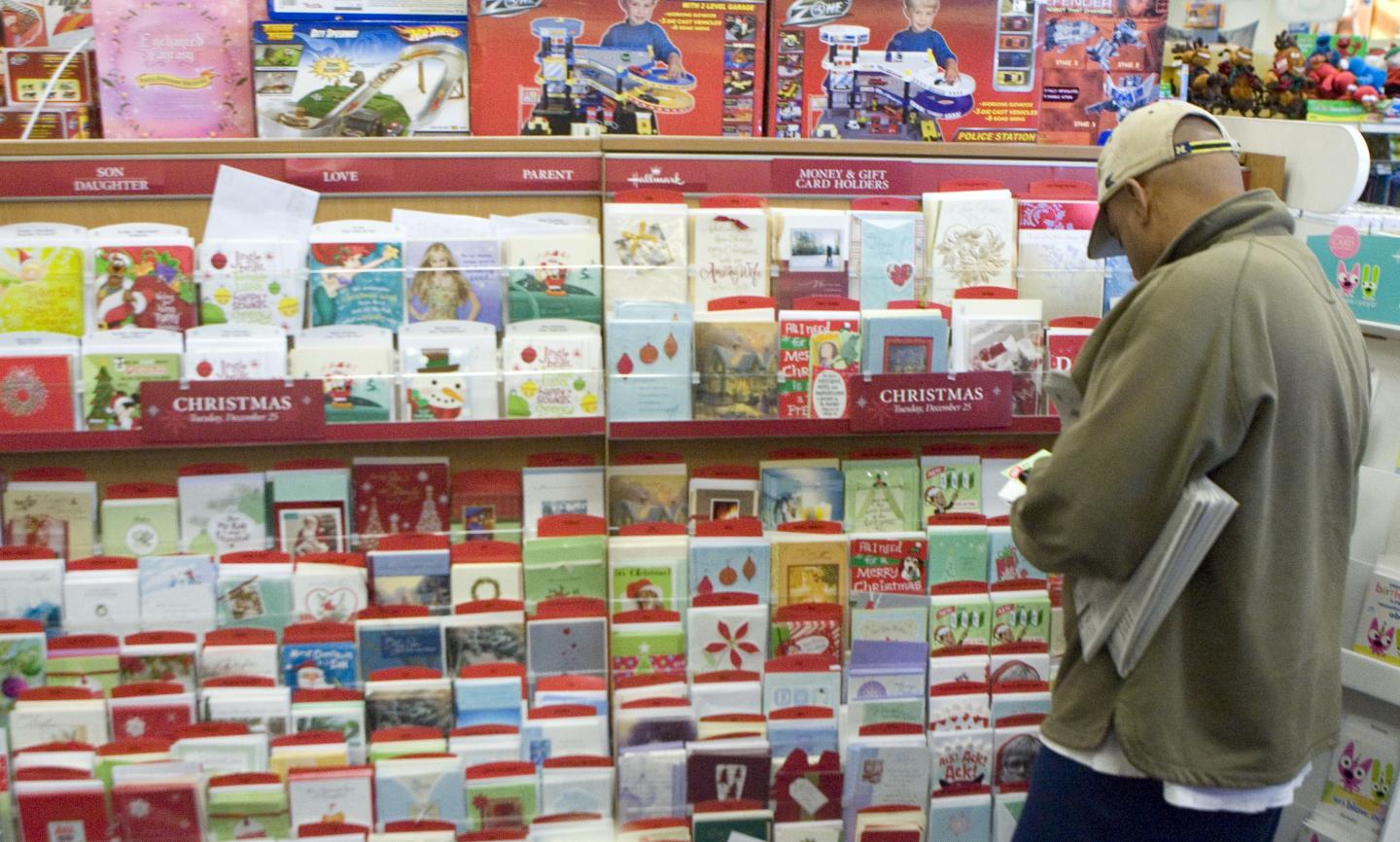 Man looks over greeting cards at CVS