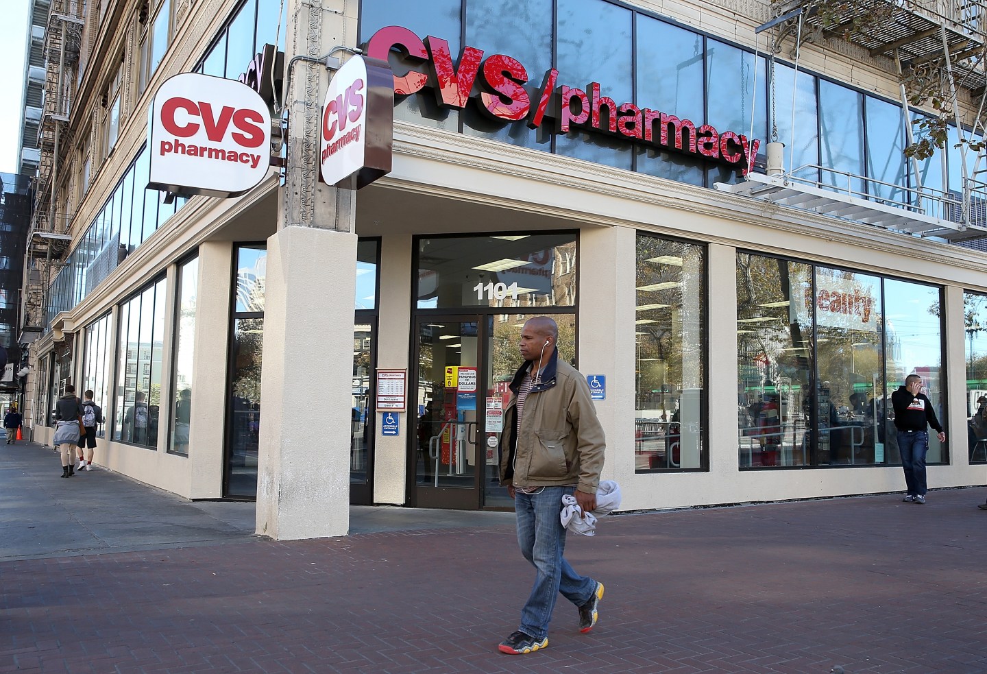 Pedestrians walk by a CVS store on November 5, 2013 in San Francisco, California.