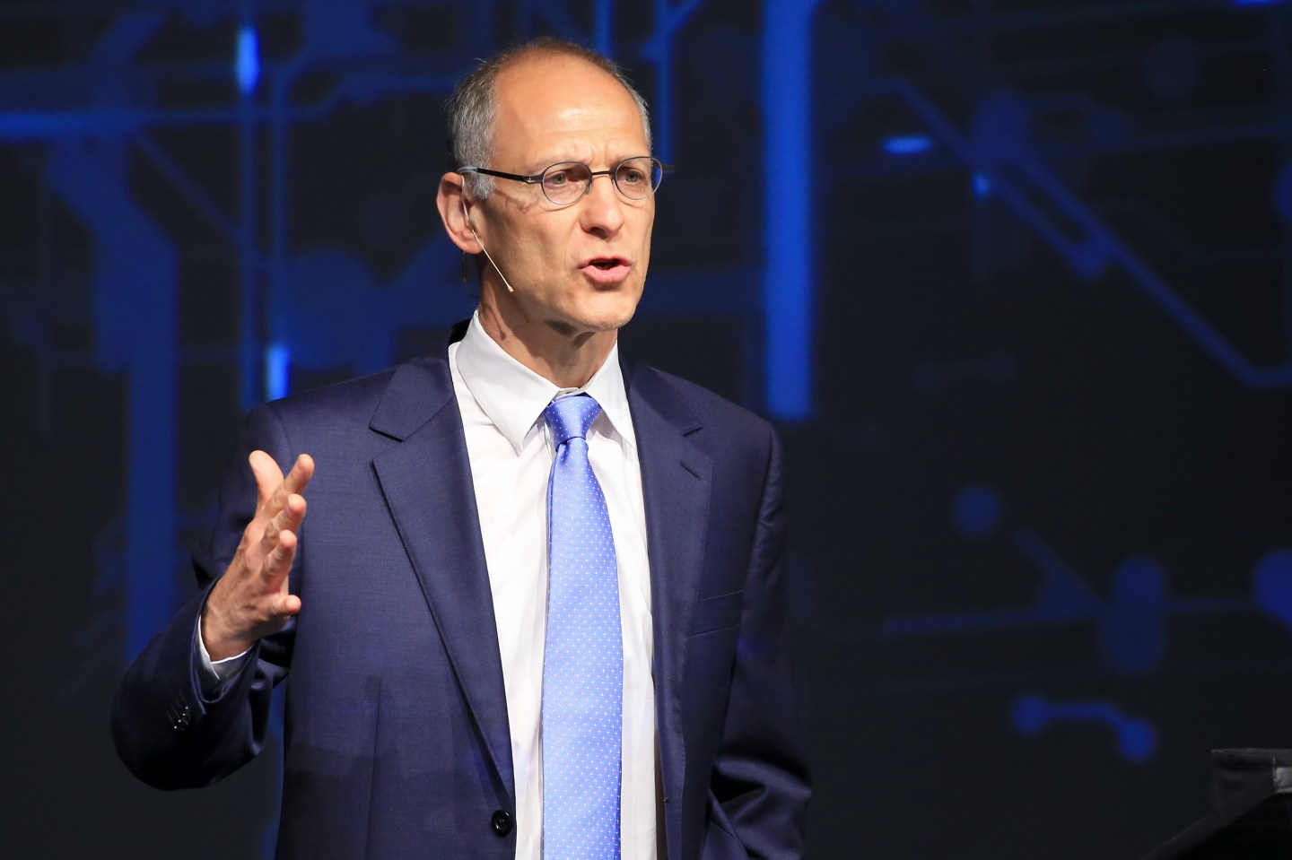 Ezekiel Emanuel speaking on stage at health conference and gesturing with his right hand in a forceful way
